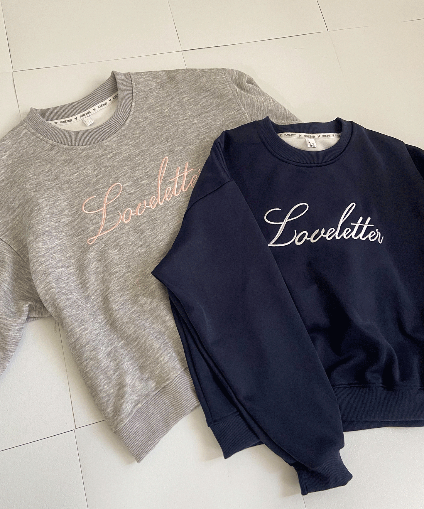 ロゴ刺繡入りトレーナー